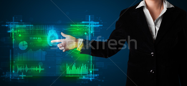 Young businesswoman pressing modern technology panel with finger Stock photo © ra2studio