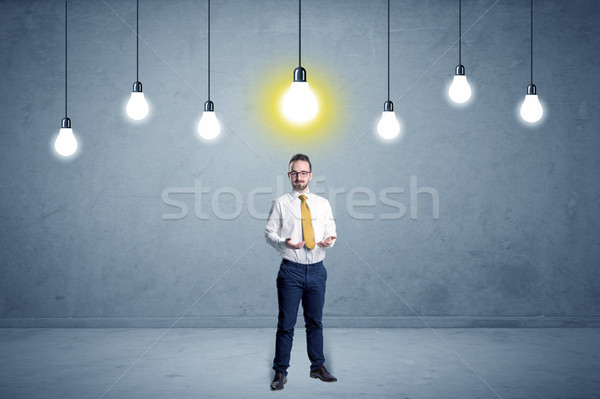 Businessman standing uninspired with bulbs above Stock photo © ra2studio
