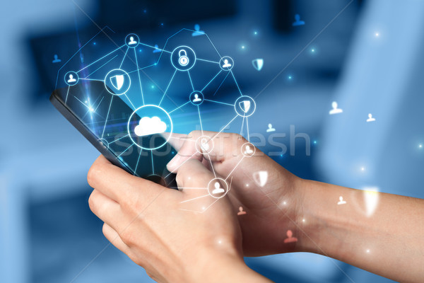 Hand using phone with centralized linked cloud system concept Stock photo © ra2studio