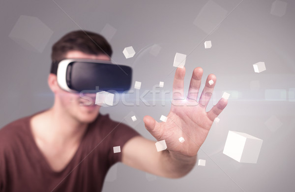 Man wearing virtual reality goggles Stock photo © ra2studio