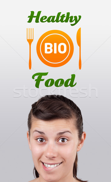 Young girl looking at healthy food sign Stock photo © ra2studio