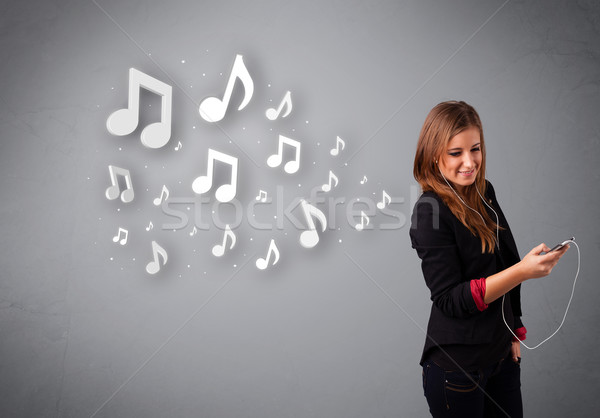 Stock photo: Pretty young woman singing and listening to music with musical notes