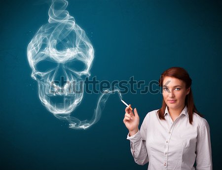 Mulher jovem fumador perigoso cigarro tóxico crânio Foto stock © ra2studio
