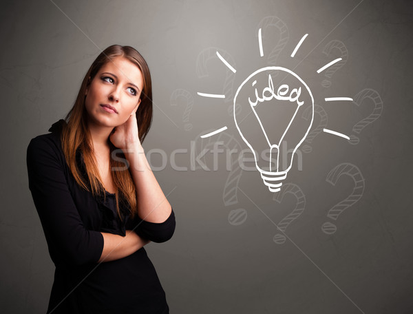 Young girl comming up with a light bubl idea sign Stock photo © ra2studio