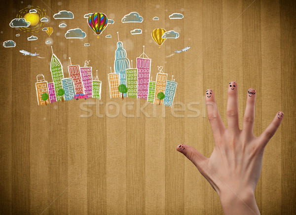 Felice dita guardando colorato cityscape Foto d'archivio © ra2studio