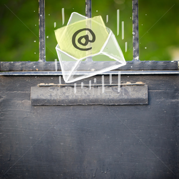 Envelope with email sign dropping into mailbox Stock photo © ra2studio