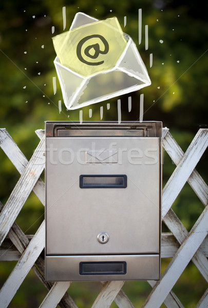 Envelope with email sign dropping into mailbox Stock photo © ra2studio