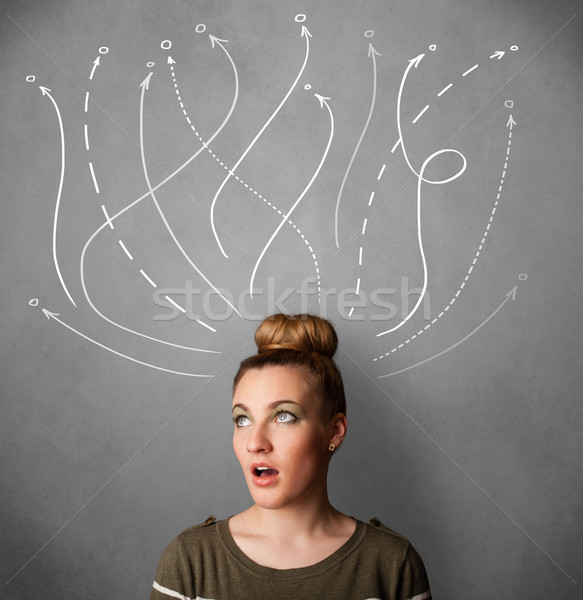 Young woman with arrows coming out of her head Stock photo © ra2studio