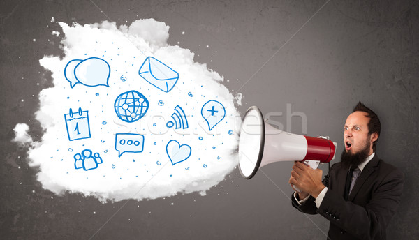 Man shouting into loudspeaker and modern blue icons and symbols  Stock photo © ra2studio