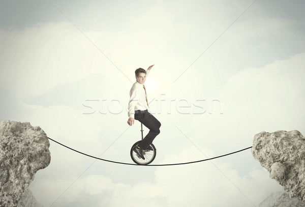 Bátor üzletember lovaglás bicikli sziklák üzlet Stock fotó © ra2studio