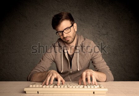 Computer geek typing on keyboard Stock photo © ra2studio