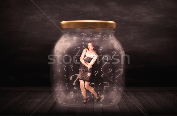 Businesswoman locked into a jar with question marks concept Stock photo © ra2studio