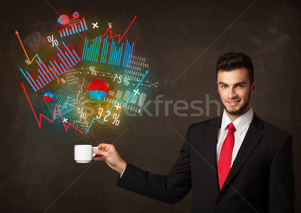 Businessman holding a white cup with diagrams and graphs Stock photo © ra2studio