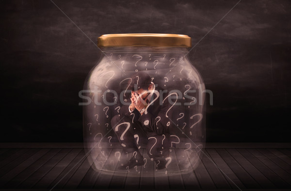 Businessman locked into a jar with question marks concept Stock photo © ra2studio