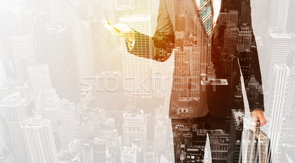 Business person with warm color overlay of city background Stock photo © ra2studio