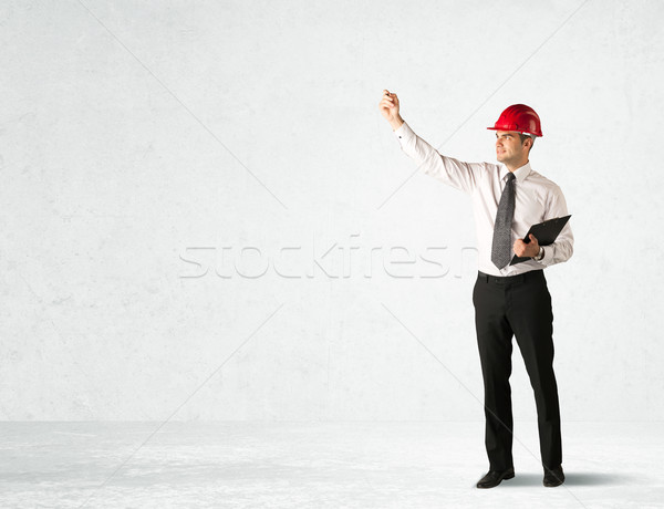 Young architect drawing in empty space Stock photo © ra2studio