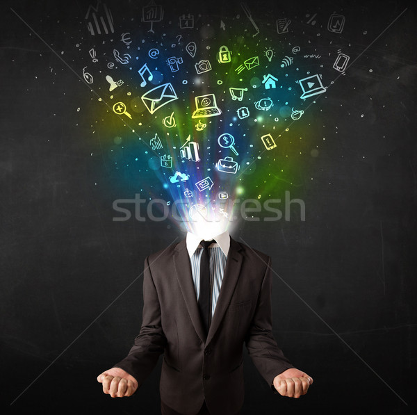 Business man with glowing media icons exploding head  Stock photo © ra2studio