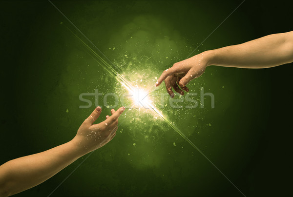Atingere arme iluminat scanteie varf degetului doua Imagine de stoc © ra2studio