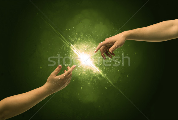 Touching arms lighting spark at fingertip Stock photo © ra2studio