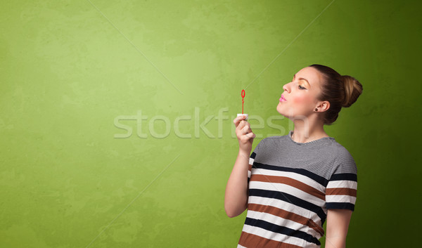 Beautiful woman blowing soap bubble on copyspace background Stock photo © ra2studio