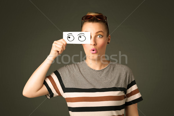 Young silly girl looking with hand drawn eye balls on paper Stock photo © ra2studio