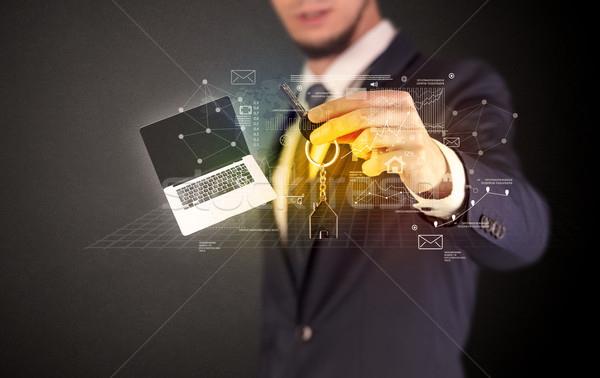Businessman holding keys with graphs around Stock photo © ra2studio