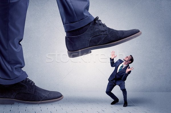 Young businessman getting crushed Stock photo © ra2studio