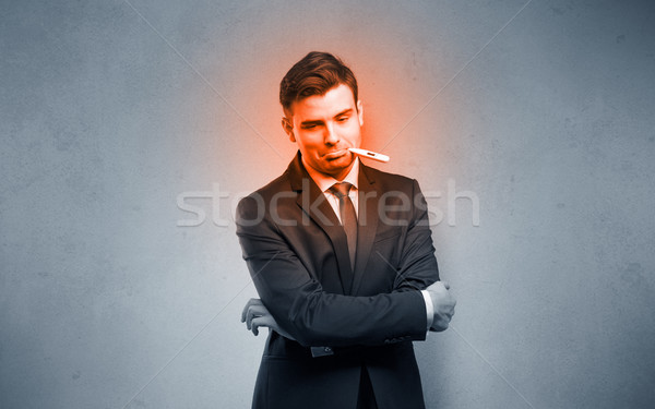 Sick businessman with burning red head concept Stock photo © ra2studio