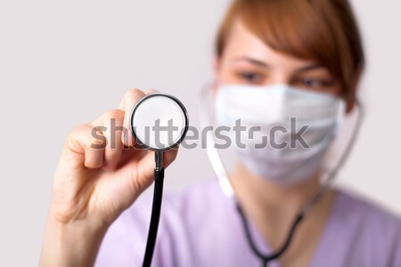 Female doctor holding stethoscope pointed toward camera 5 Stock photo © ra2studio