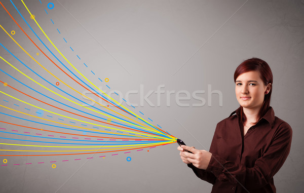 Boldog lány tart telefon színes absztrakt vonalak Stock fotó © ra2studio