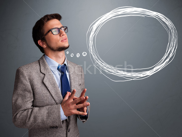 Good-looking young man thinking about speech or thought bubble Stock photo © ra2studio