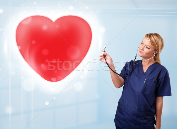 Jovem enfermeira cura vermelho coração bastante Foto stock © ra2studio