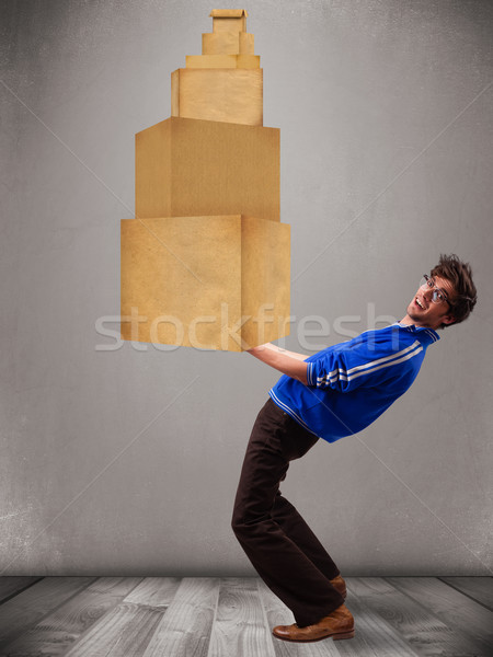 Young man holding a set of brown cardboard boxes Stock photo © ra2studio