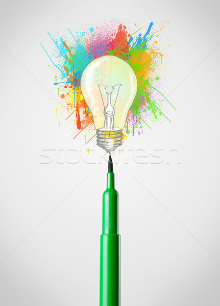 Stock photo: Felt pen close-up with colored paint splashes and lightbulb