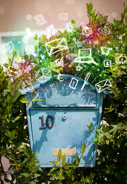 Colorful icons and symbols bursting out of a mailbox Stock photo © ra2studio