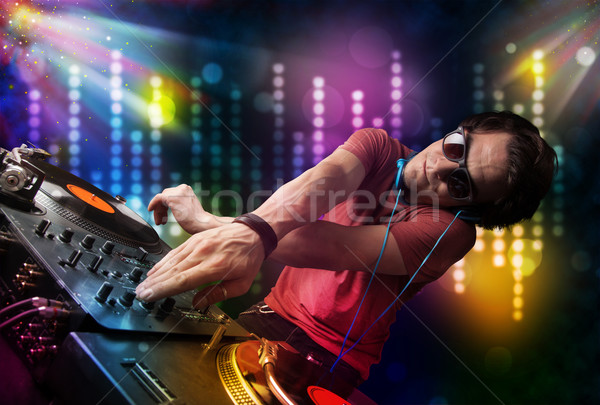 Dj playing songs in a disco with light show Stock photo © ra2studio
