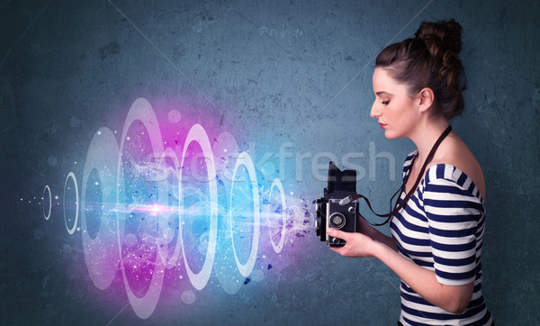 Photographer girl making photos with powerful light beam Stock photo © ra2studio