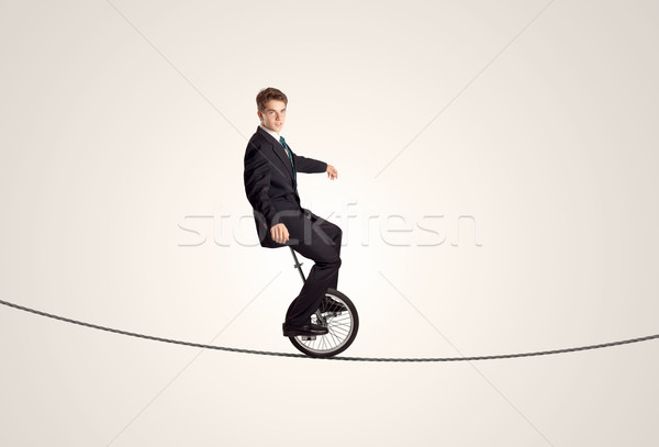 Ekstremalnych człowiek biznesu jazda konna monocyklu liny człowiek Zdjęcia stock © ra2studio