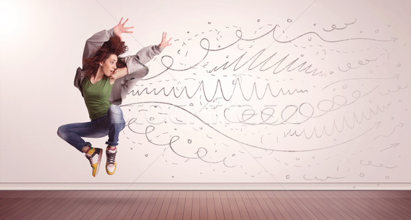 Stock photo: Pretty woman jumping with hand drawn lines and arrows come out