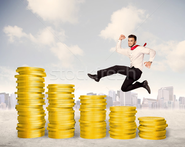 Bem sucedido homem de negócios saltando para cima moeda de ouro dinheiro Foto stock © ra2studio