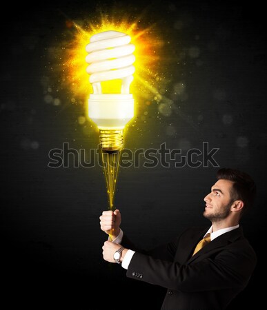 Stock photo: Businessman with an eco-friendly bulb