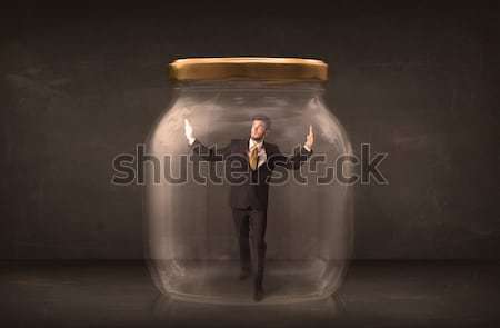 Businessman shut into a glass jar concept Stock photo © ra2studio