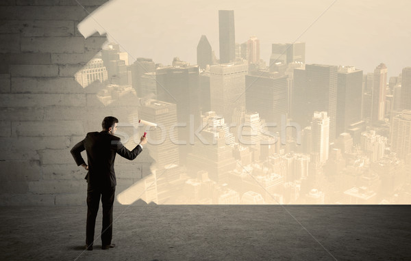 Salesman painting city scape on wall Stock photo © ra2studio