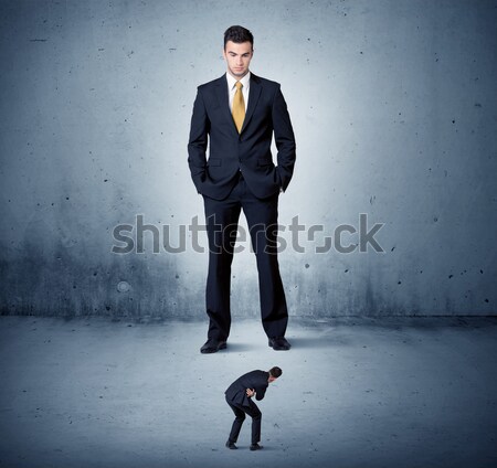 Angry huge business man lokking at small guy Stock photo © ra2studio