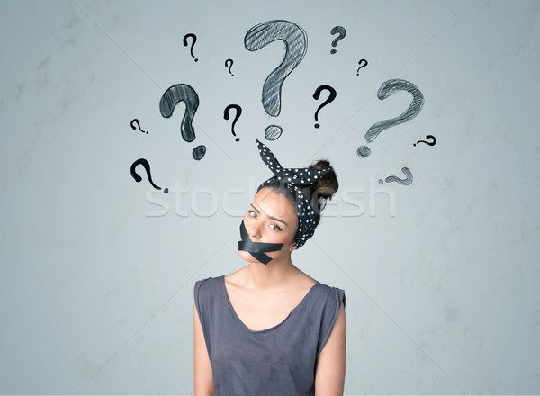 Young woman with glued mouth and question mark symbols Stock photo © ra2studio