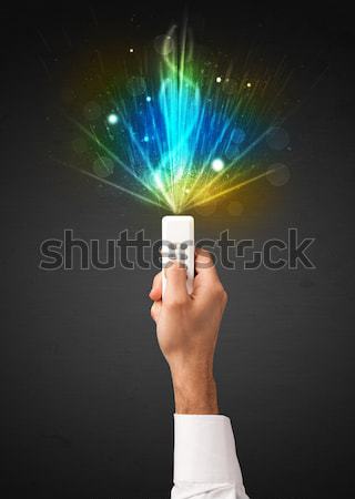 Hand with remote control and explosive signal Stock photo © ra2studio