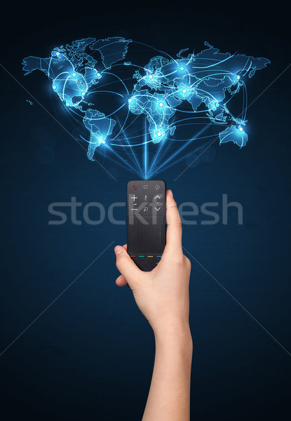 Hand with remote control, social media concept Stock photo © ra2studio