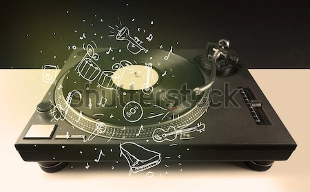 Stock photo: Turntable playing classical music with icon drawn instruments 