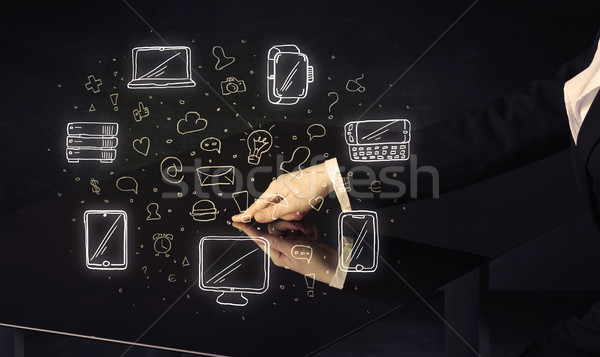 Man pressing table tablet hand touch interface with media icons Stock photo © ra2studio