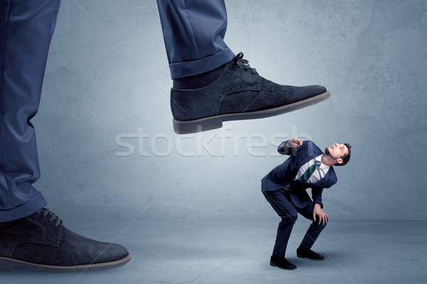 Trampled small businessman in suit Stock photo © ra2studio